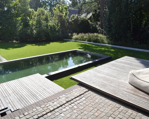 Terraces floating as thin sheets above the garden and the pool